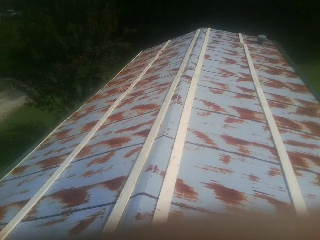 Rusted metal roof panels with new wood purlins before replacement — Storm Damage Roof Repair in Lake Peekskill by Roofing Brothers