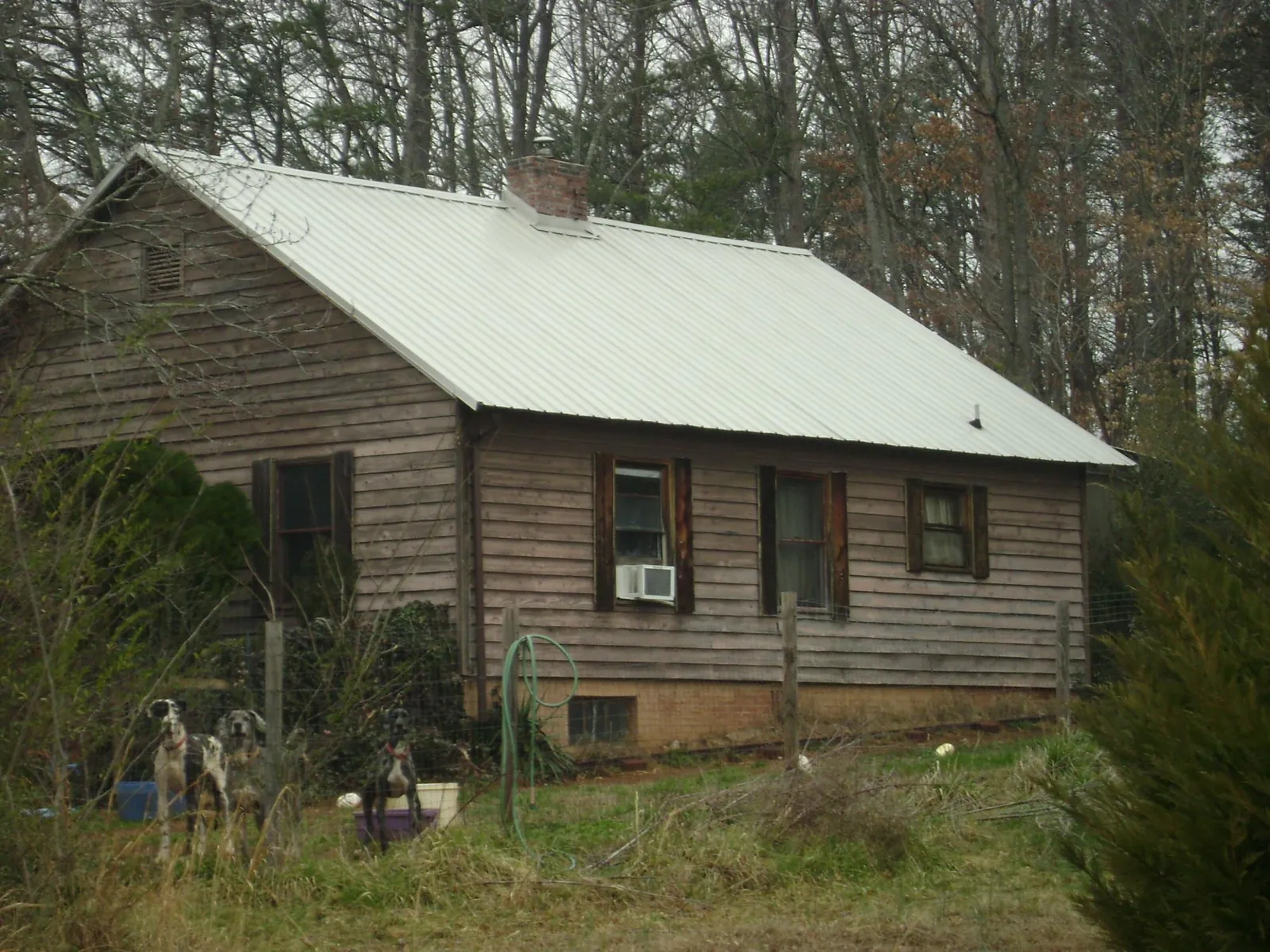White metal roof on an old wood sided farmhouse, from a Metal Roof Installation job in Lake Peekskill